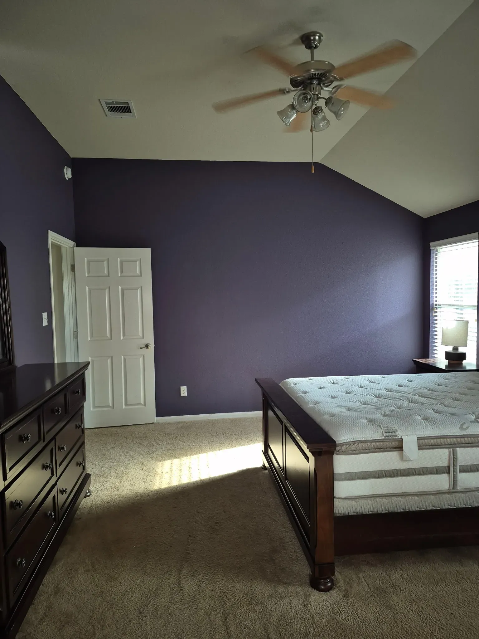 Bedroom with walls painted deep purple