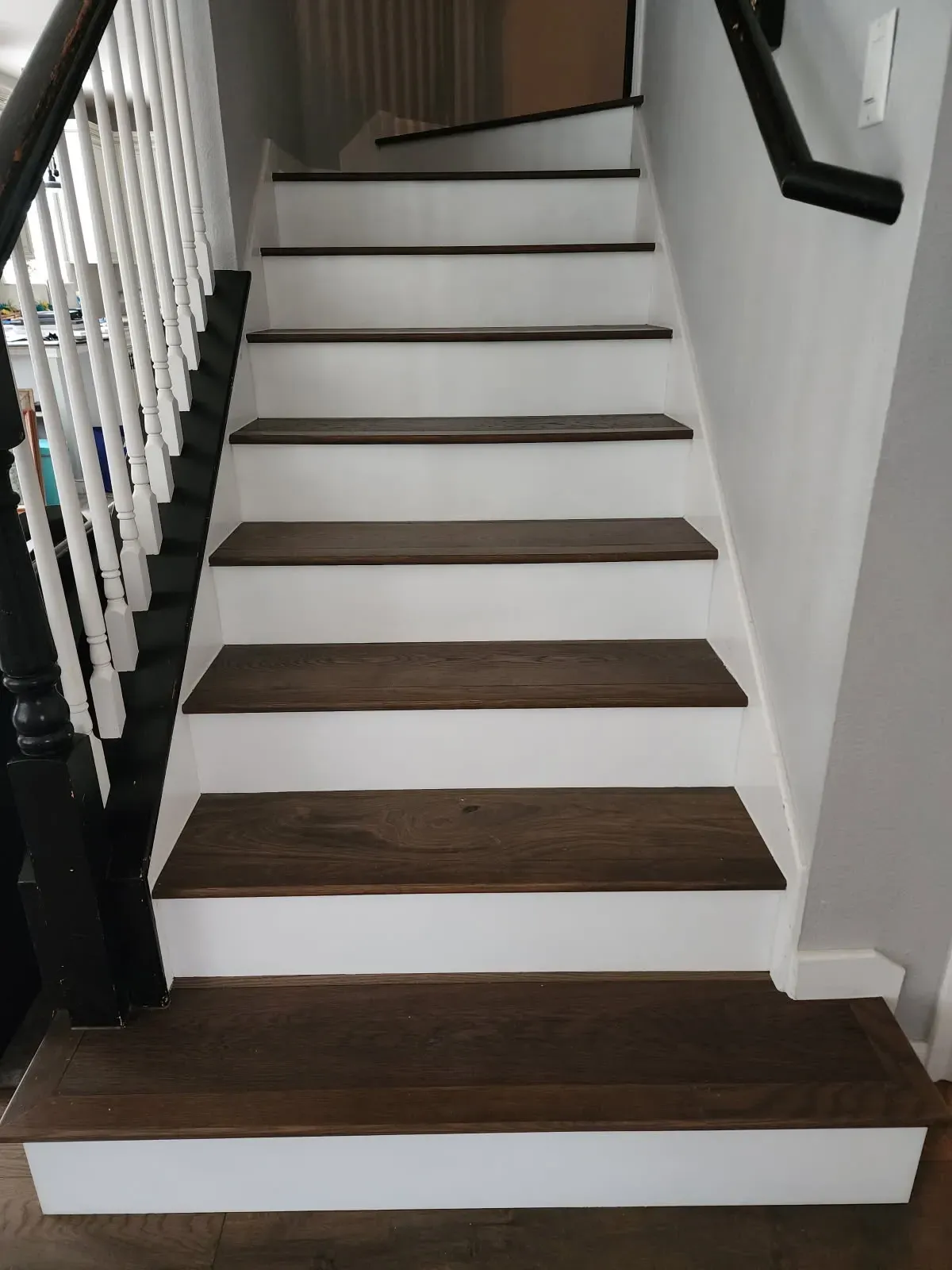 Dark stained oak stair treads with white painted r