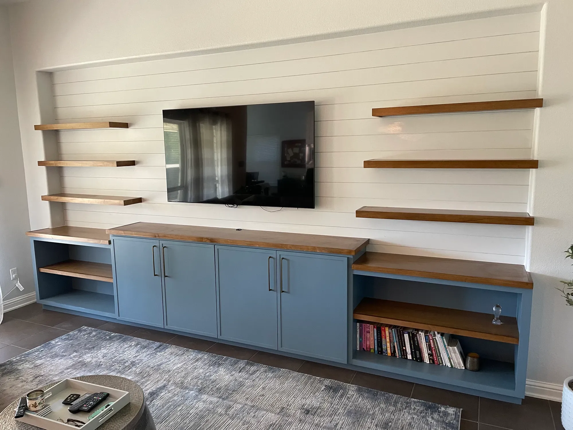 Floating shelves above a custom cabinet run in Austin
