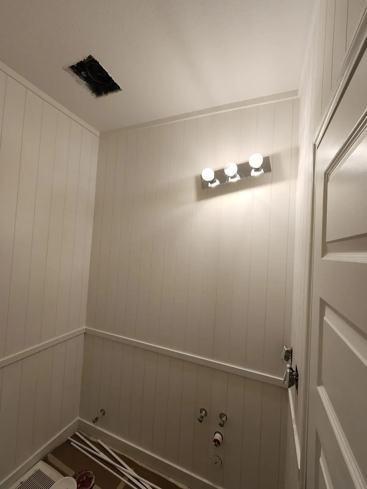 Paneling and wainscotting installed on bathroom wa